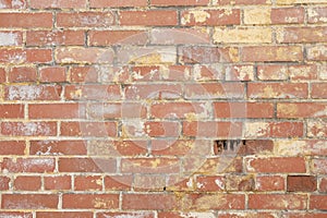 Background of a damaged red brick wall