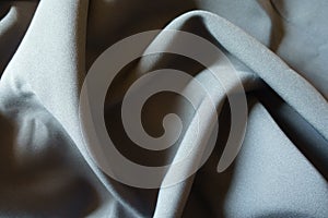 Background - dark gray viscose and polyester fabric in soft folds