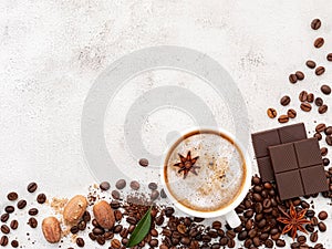 Background of dark roasted coffee bean and with dark chocolate on white concrete background with copy space