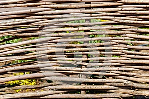 Background of decorative rustic village wicker fence