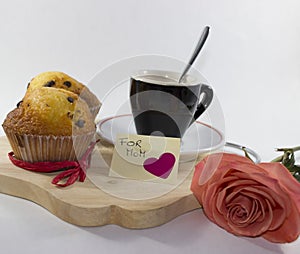 Background dedicated to Mother`s Day, with two muffins, a black