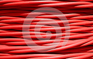 background of detailed red electrical cable used for high voltage power transmission from a power plant to substations