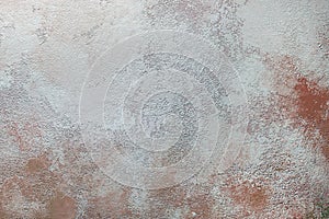 the background is a dirty wall. Stains and red streaks on the old textured plaster of the wall