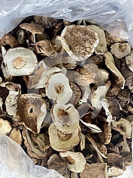 Background of dried edible mushrooms on the market closed up top view.