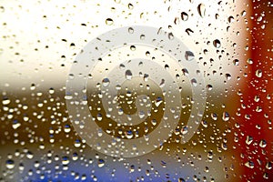 Background of a drop on the glass with colored stripes