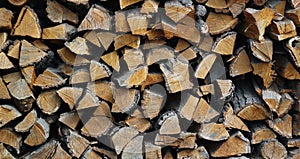 Background of dry chopped firewood logs in a pile