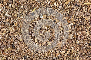 Background of dry crushed elecampane root. The Latin name for the herbal mixture is Rhizomata et radices Inulae