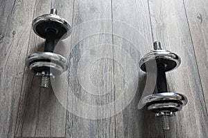 Background with dumbbells on a wooden floor