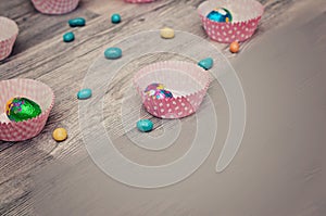 Background for Easter. Easter eggs on wooden planks. Colorful easter eggs on wooden background