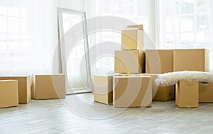 Background empty nobody comfortable room in a home or apartment with many unpacking carton paper boxes for moving to new house and