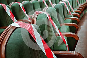 Background of empty seats in the cinema, theater, auditorium with a warning label. Presentation of a conference, opera, theatrical