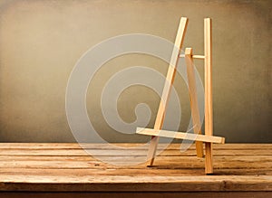 Background with empty wooden easel