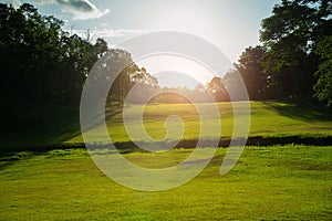 Background of evening golf course has sunlight shining down at golf course in Thailand