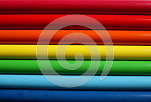 The background is filled with horizontal three dimensional stripes. Colors of the rainbow. Photo