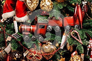 Background of fir tree with red toy train and christmas decoration