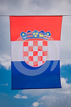 Background from the flag of Croatia, developing against the sky and clouds