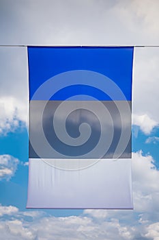 Background from the flag of Estonia, developing against the sky and clouds