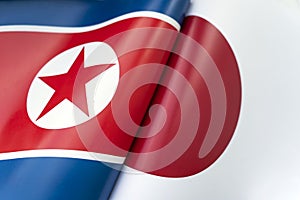 Background of the flags of north korea and Japan. The concept of interaction or counteraction between the two countries