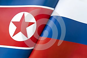 Background of the flags of the north korea and Russia. The concept of interaction or counteraction between the two