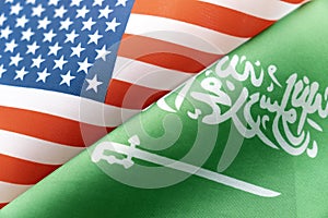 Background of the flags of the USA and saudi arabia. The concept of interaction or counteraction between two countries.
