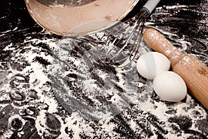 Background from flour, eggs and rolling pin. Ingredients for baking on background