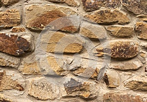 Background in the form of a stone wall made of many flat buta stones of light color