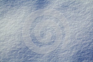 Background in the form of a wavy surface of snow in a field in natural daylight