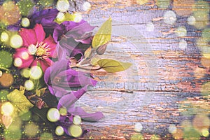 Background with fresh blue Clematis flowers on old wooden planks