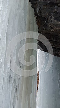 The background of a frozen waterfall, large icicles, the waterfall is located in RSO-Alanya