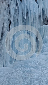 The background of a frozen waterfall, large icicles, the waterfall is located in RSO-Alanya