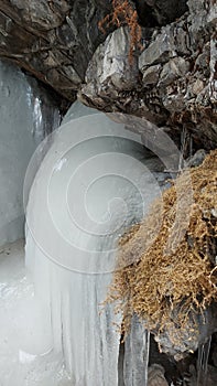 The background of a frozen waterfall, large icicles, the waterfall is located in RSO-Alanya