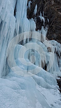The background of a frozen waterfall, large icicles, the waterfall is located in RSO-Alanya