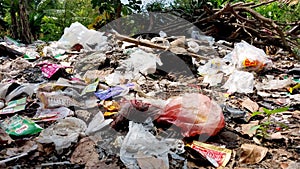 Background of garbage. Piles of undecomposed garbage. Plastic garbage fills the yard. The concept of environmental pollution