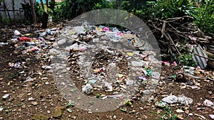 Background of garbage. Piles of undecomposed garbage. Plastic garbage fills the yard. The concept of environmental pollution