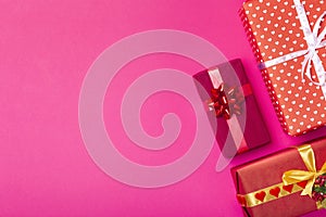 Background of gifts, boxes wrapped in decorative paper on a colored background, top view, holiday concept