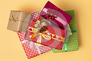 Background of gifts, boxes wrapped in decorative paper on a colored background, top view, holiday concept