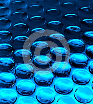 A background of glossy blue bubbles.