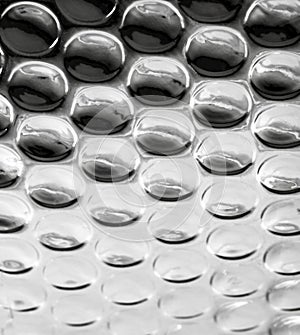 A background of glossy gray bubbles.