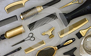 Background with gold and black hair salon accessories.