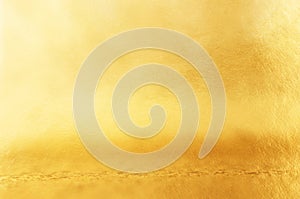 Background of gold foil texture with light reflections