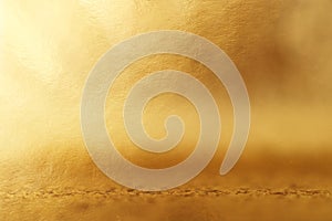 Background of gold foil texture with light reflections