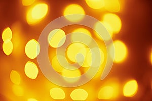 Background of golden lights in a bokeh. Defocused abstract blurred lights