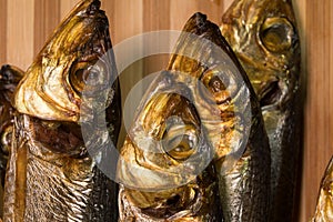 Background of golden smoke-dried fish close up