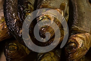 Background of golden smoke-dried fish close up