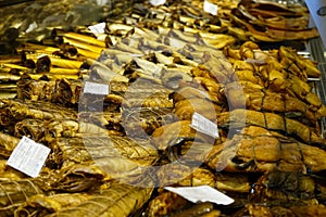 Background of golden smoke-dried fish close up