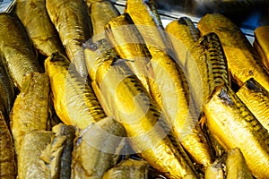 Background of golden smoke-dried fish close up