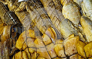 Background of golden smoke-dried fish close up