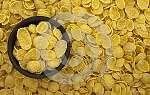 Background of goldish corn flakes with dish photo