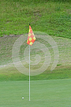 Background of golf ball near hole on putting green