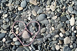 Gray stones with pink heart shaped rope